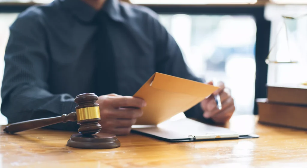 a person looking at court documents with a gavel