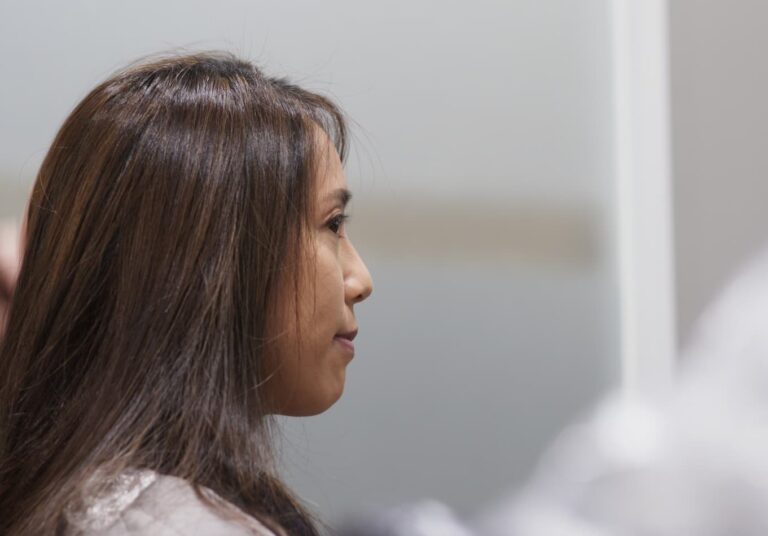 Woman waiting with calm expression symbolizing pre-trial or record sealing process